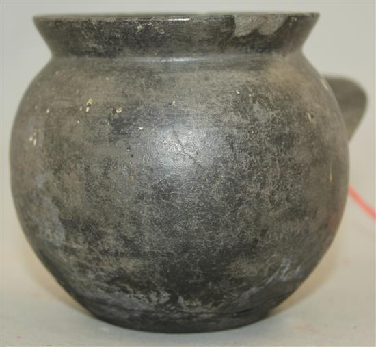 An Etruscan Bucchero ware single handled cup, c. 6th century BC, 9cm, repaired